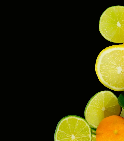 Stacks of sliced fruit isolated on black — Stockfoto