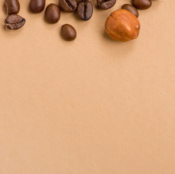 Coffee beans and nut on old paper — Stock Photo, Image