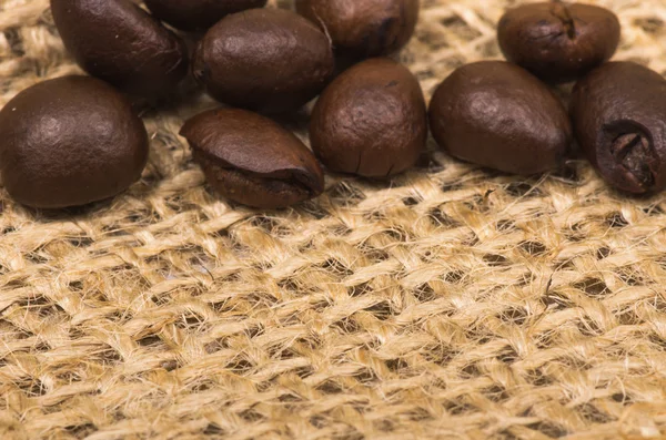 Coffee beans on sack — Stock Photo, Image