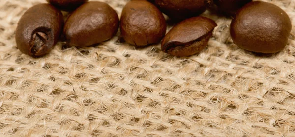 Coffee beans on sack — Stock Photo, Image