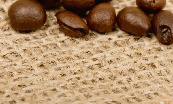 Coffee beans on sack — Stock Photo, Image