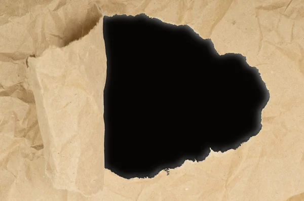 Ripped paper against a black — Stock Photo, Image
