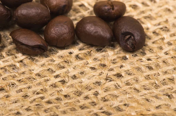 Coffee beans on sack — Stock Photo, Image