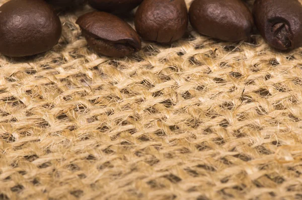 Coffee beans on sack — Stock Photo, Image