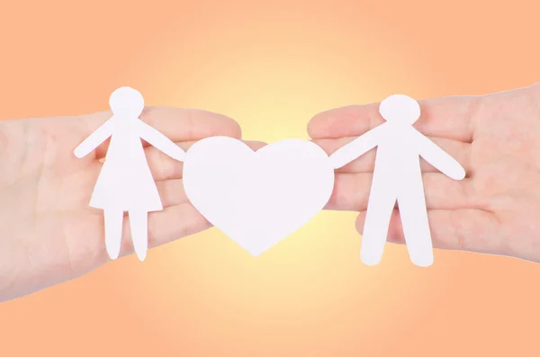 Paper family with a big heart in hands — Stock Photo, Image