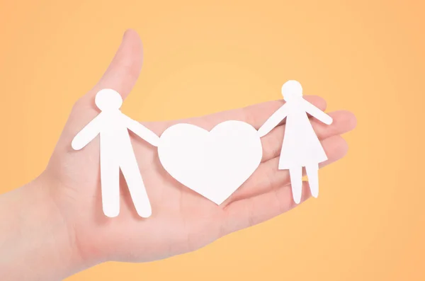 Paper family with a big heart in hand — Stock Photo, Image