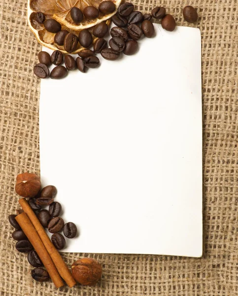 Paper, coffee beans, cinnamon, lemon — Stock Photo, Image