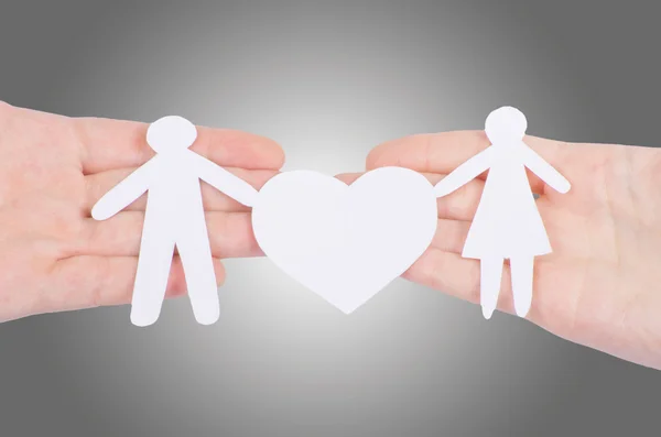 Paper family with a big heart in hands — Stock Photo, Image