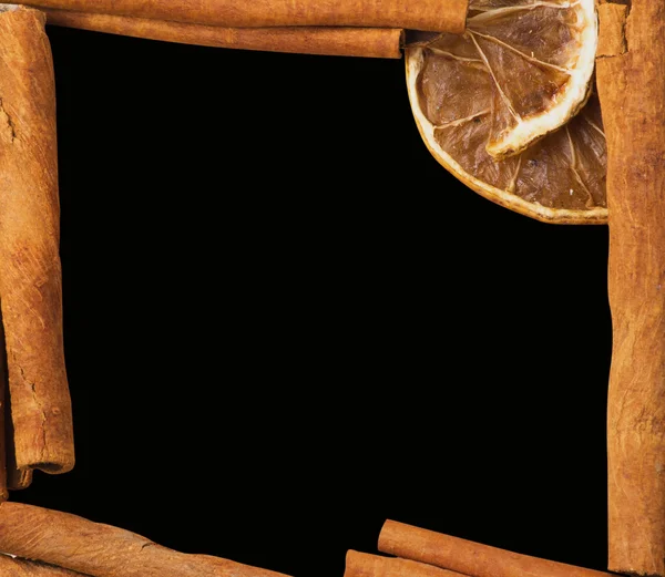 Cinnamon and lemon on dark — Stock Photo, Image