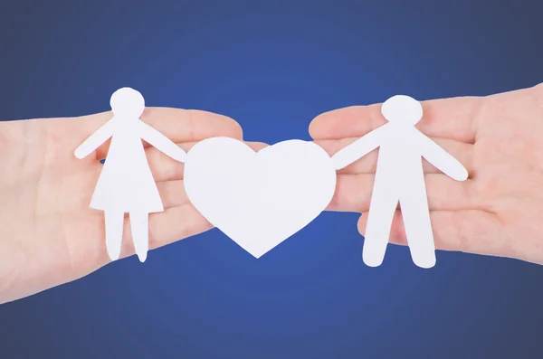 Paper family in hand with heart — Stock Photo, Image