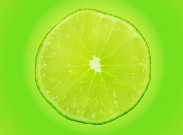 Lime slice on green — Stock Photo, Image