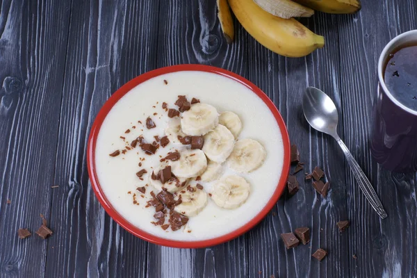 Semolina porridge with banana and chocolate for breakfast — Stock Photo, Image