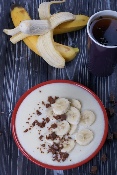 Semolina porridge with banana and chocolate for breakfast — Stock Photo, Image