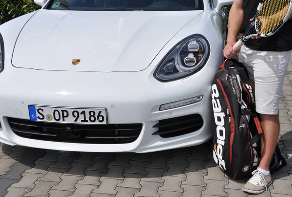 Porsche Panamera and tennis rackets — Stock Photo, Image