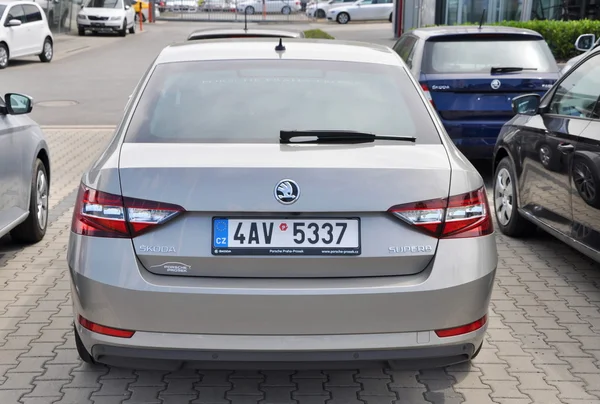 Skoda Superb in front of car store