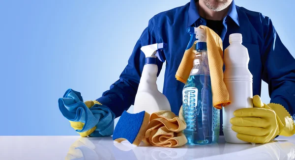 Cleaning service products and uniformed employee — Stock Photo, Image