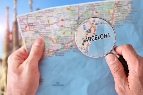 Man consulting a map of Barcelona with a magnifying glass