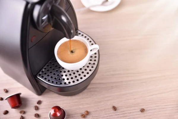 Espresso machine making coffee on wood table elevated view — Stock Photo, Image