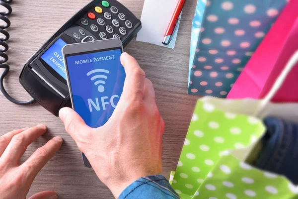 Pagamento em um comércio com telefone nfc sistema vista superior — Fotografia de Stock