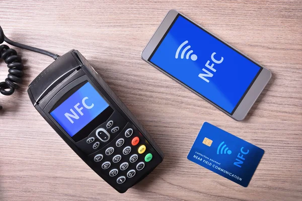 POS card and mobile on wood table nfc transmision system — Stock Photo, Image