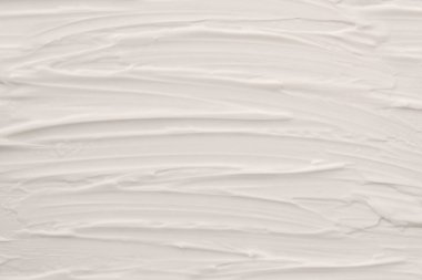 Beyaz kozmetik cilt kremi dokusu sürükleniyor. Yatay bileşim.