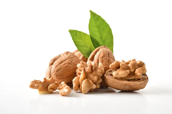 Walnuts Shell Broken Showing Seeds Leaves White Table White Isolated — Stock Photo, Image