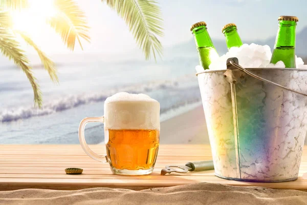 Beer mug and ice bucket filled with beer bottles on wooden base and beach background with palm tree