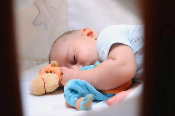 Baby sleeping in his crib — Stock Photo, Image