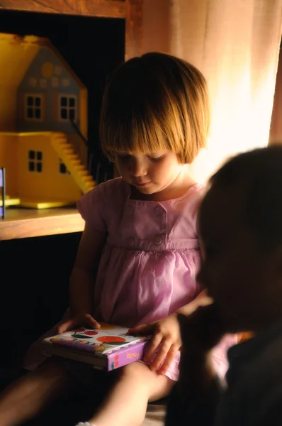 Girl watching an educational book — Stock Photo, Image