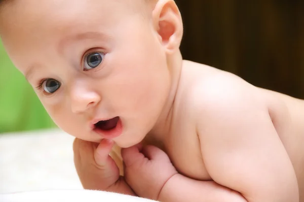 Surprised baby on bed — Stock Photo, Image