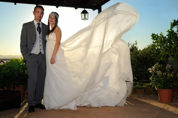 Bride and groom under a porch full length — Stock Photo, Image