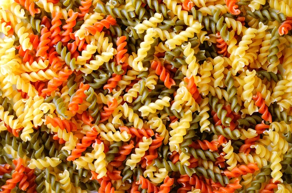 Colorful background texture uncooked pasta — Stock Photo, Image