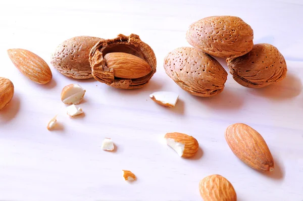 Group fo almonds on a white table top view — Stock Photo, Image