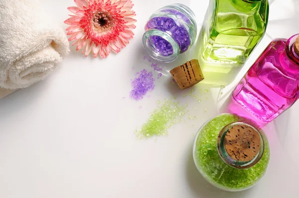 Oils and bath salts on white glass table top view — Stock Photo, Image