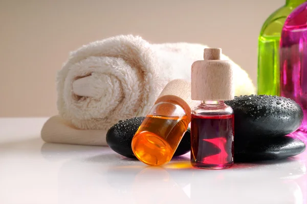 Oils stones and towel on white table front view — Stock Photo, Image