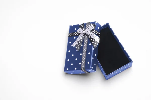Small open blue gift box with ribbon and circles top — Stock Photo, Image