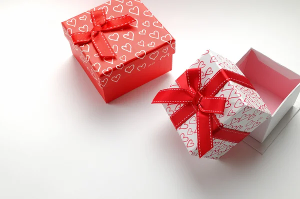 Two decorative gift boxes with hearts printed isolated top right — Stock Photo, Image