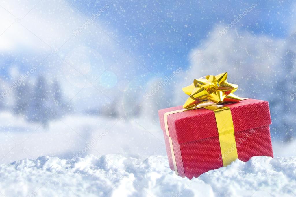 Gift box on snow at Christmas outside