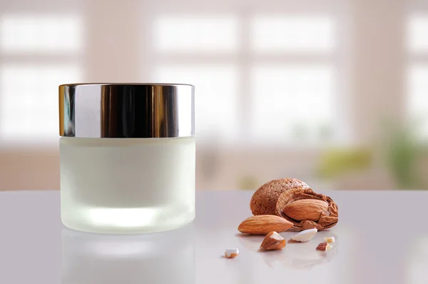 Almond moisturizer cream jar closed windows background — Stock Photo, Image