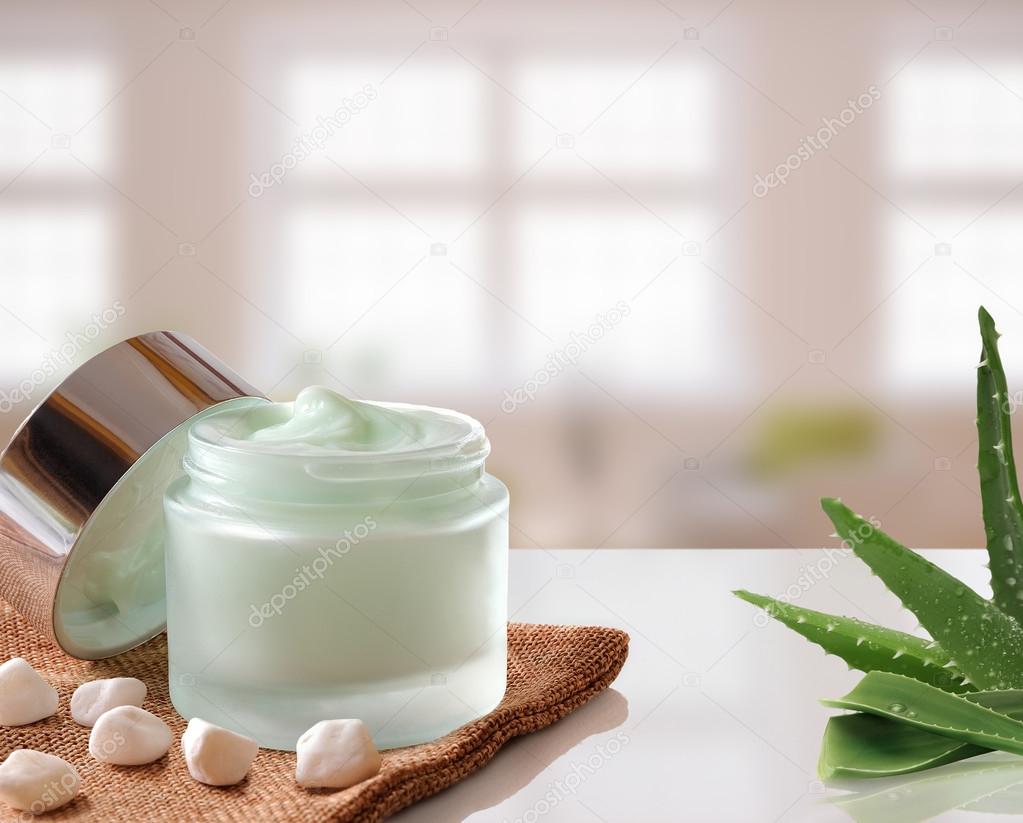 Aloe Vera Cream jar open on burlap windows background