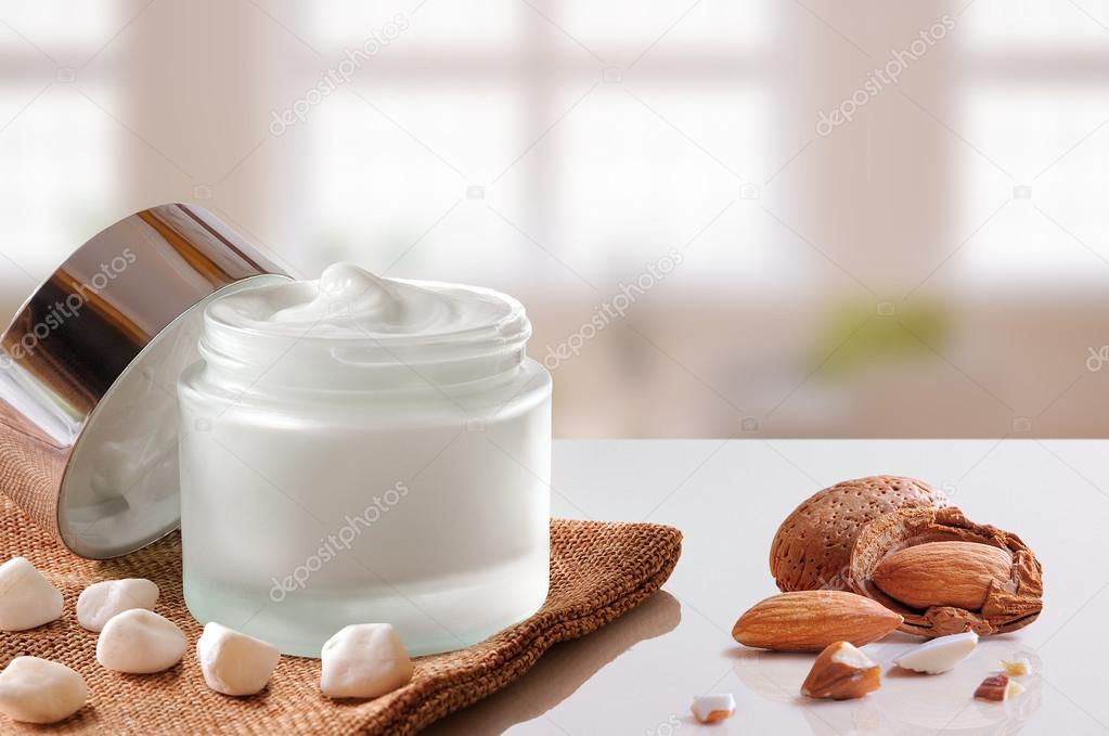 Almond moisturizer jar open on burlap windows background