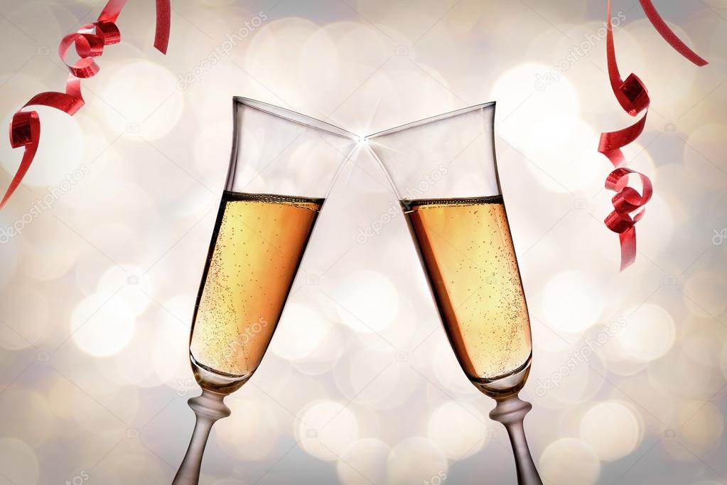 Two glasses of sparkling white wine toasting bokeh background