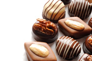 Assorted bonbons on a white table Top view Close up