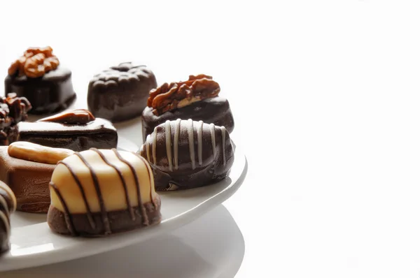 Assorted bonbons on a white plate Front view — Φωτογραφία Αρχείου