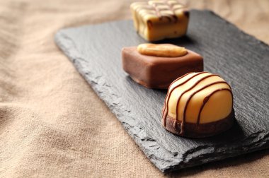 Assorted bonbons on a slate plate close up