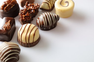 Assorted bonbons on a white table Top diagonal aligned