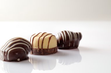 Three bonbons on a white table Front view Close up