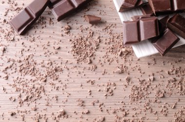 Portions and sparse chocolate chips on wood table top view