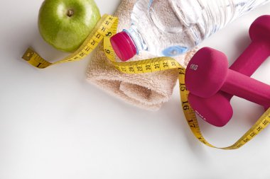 Dumbbells with apple bottle and tape measure and towel top