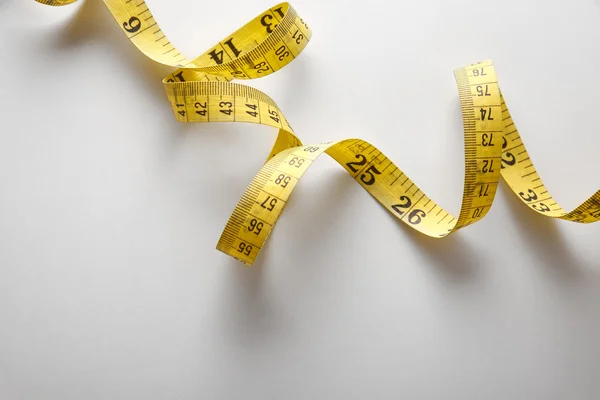 Yellow tape measure in meters and inches in a spiral — Stok fotoğraf